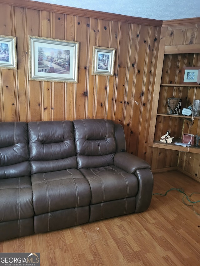 living room with wooden walls and light wood-type flooring