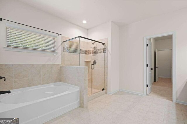 bathroom with tile patterned flooring and plus walk in shower