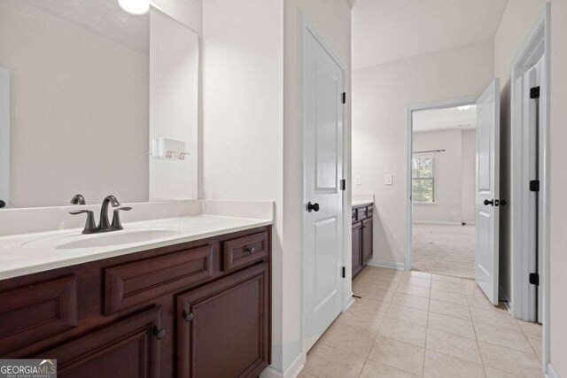 bathroom with tile patterned flooring and vanity