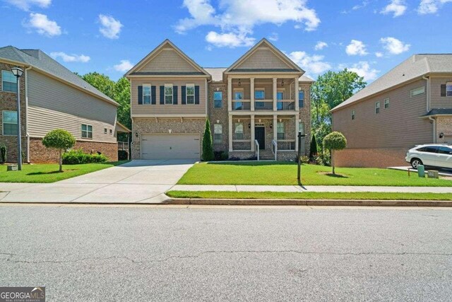 view of front of home with a garage and a front lawn