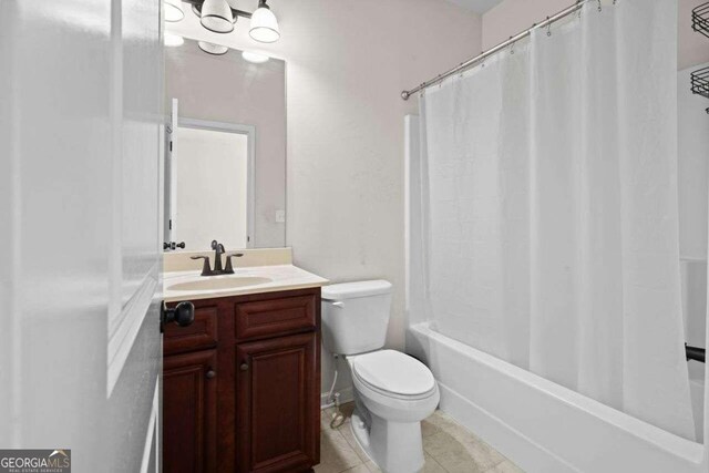 full bathroom featuring tile patterned flooring, vanity, toilet, and shower / bath combination with curtain