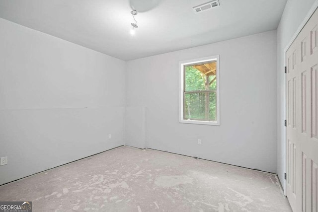 unfurnished bedroom featuring a closet and concrete floors