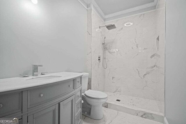 bathroom with tile patterned flooring, toilet, a tile shower, and vanity