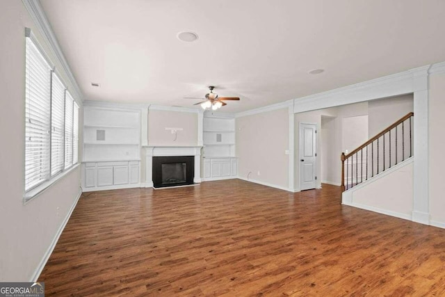 unfurnished living room with hardwood / wood-style floors, built in shelves, and ceiling fan