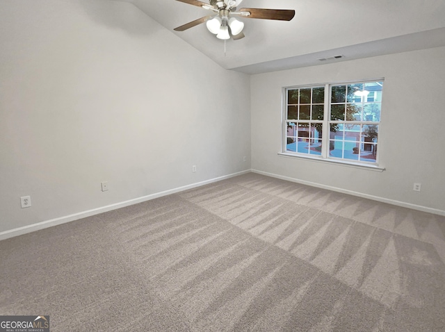 unfurnished room featuring carpet, lofted ceiling, and ceiling fan