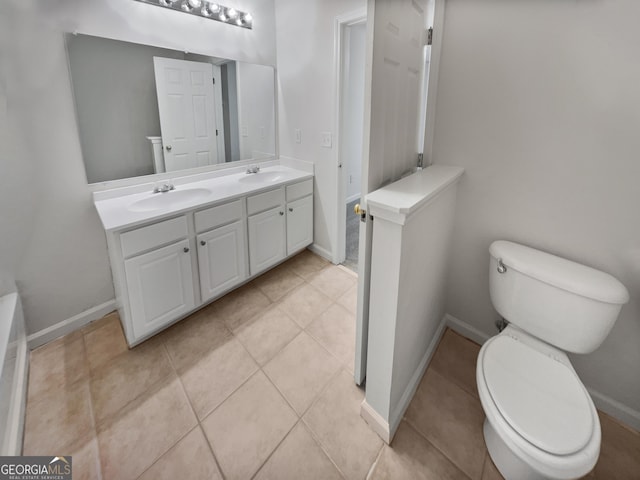 bathroom featuring toilet, tile patterned floors, and vanity