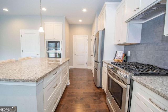 kitchen with appliances with stainless steel finishes, decorative backsplash, dark hardwood / wood-style flooring, and white cabinetry