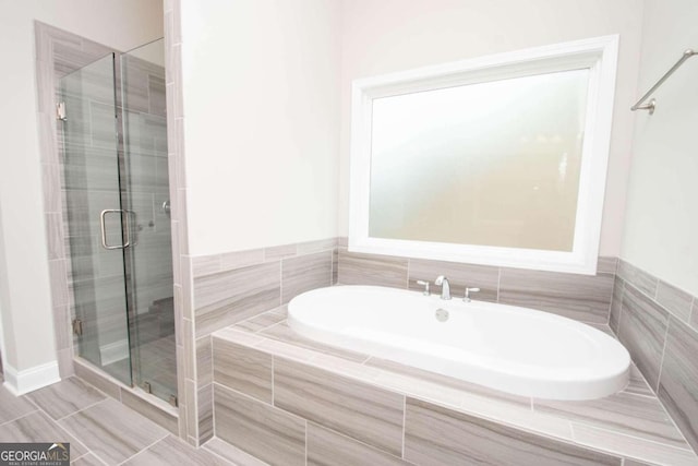 bathroom featuring tile walls, separate shower and tub, and tile patterned floors