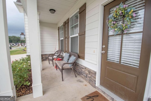 view of exterior entry with a porch