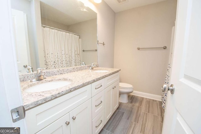 bathroom featuring tile patterned floors, toilet, vanity, and a shower with curtain