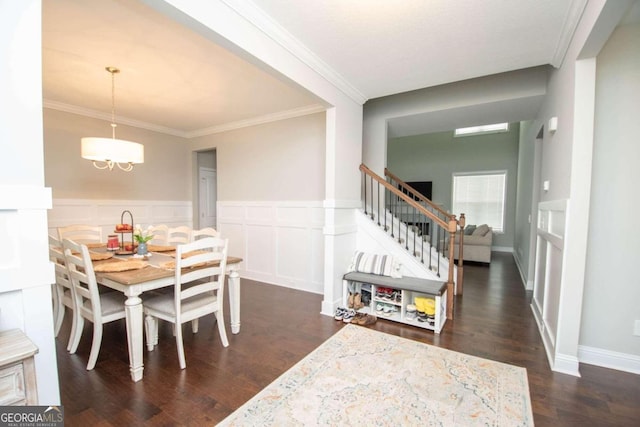 dining area with dark wood-type flooring and ornamental molding