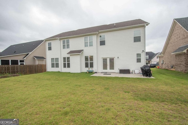 back of house with a patio and a yard