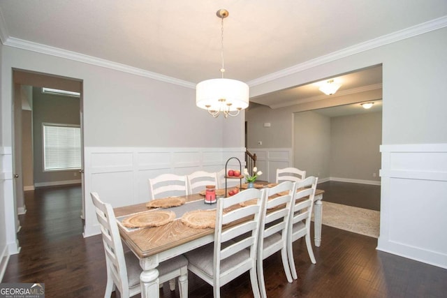 dining area featuring a notable chandelier, dark wood-type flooring, and ornamental molding