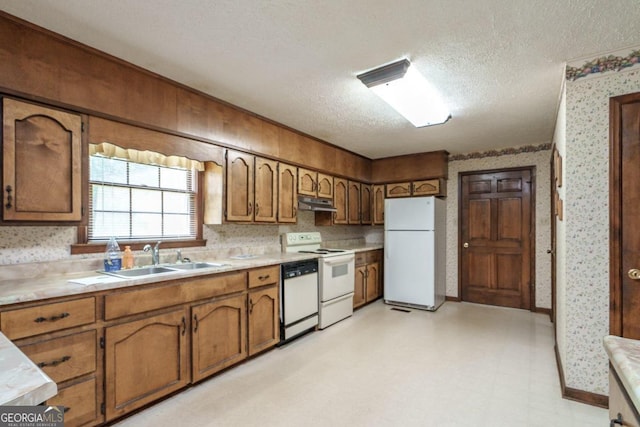 kitchen with sink, a textured ceiling, light tile patterned flooring, and white appliances