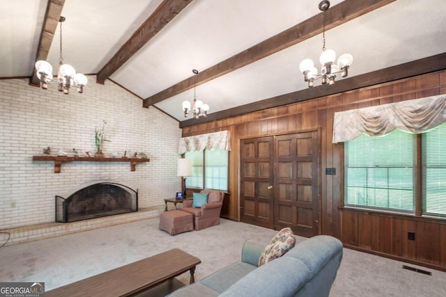 carpeted living room with brick wall, a chandelier, lofted ceiling with beams, and a brick fireplace