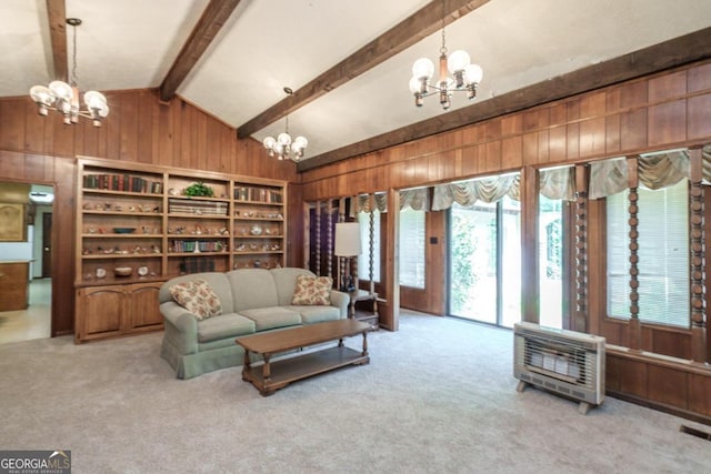 carpeted living room featuring vaulted ceiling with beams, wooden walls, and a chandelier