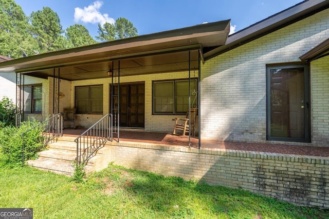 back of property featuring covered porch