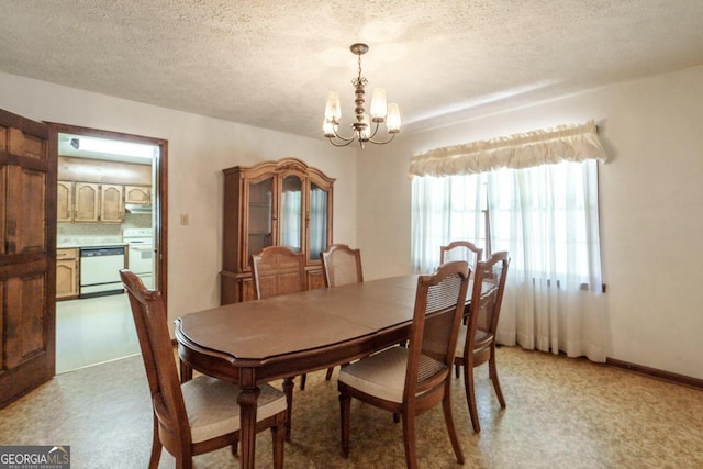 dining room with a textured ceiling, a notable chandelier, and light colored carpet