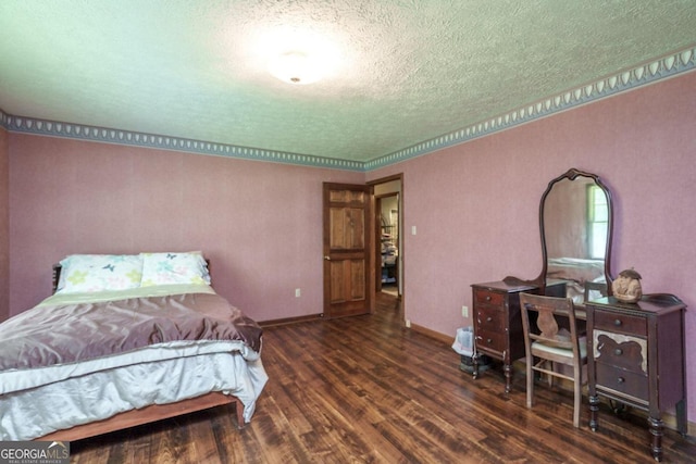 bedroom with a textured ceiling and hardwood / wood-style flooring