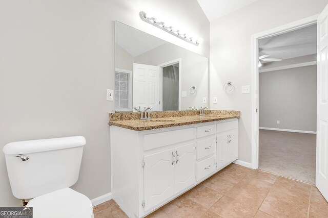 bathroom with ceiling fan, tile patterned flooring, toilet, and vanity