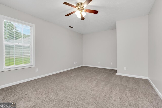 unfurnished room featuring ceiling fan and light carpet