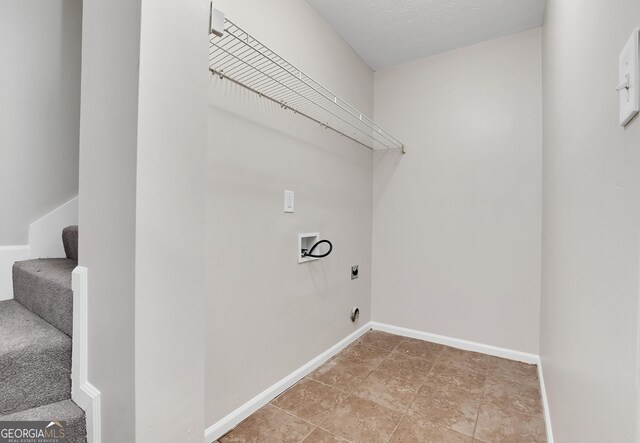 laundry area with tile patterned floors, electric dryer hookup, and washer hookup