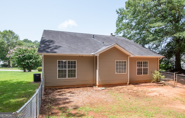 back of house featuring a yard and cooling unit