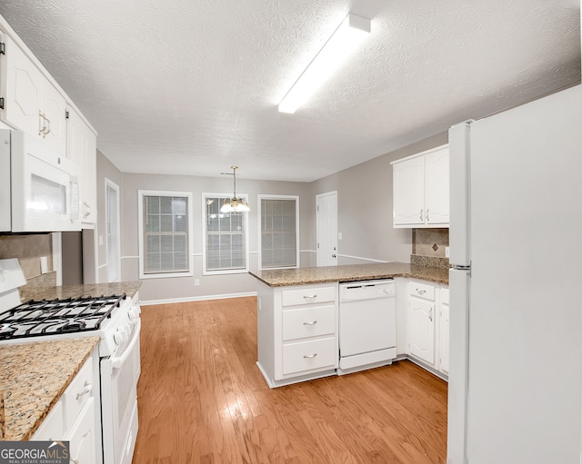 kitchen featuring light wood-type flooring, kitchen peninsula, white appliances, and white cabinets