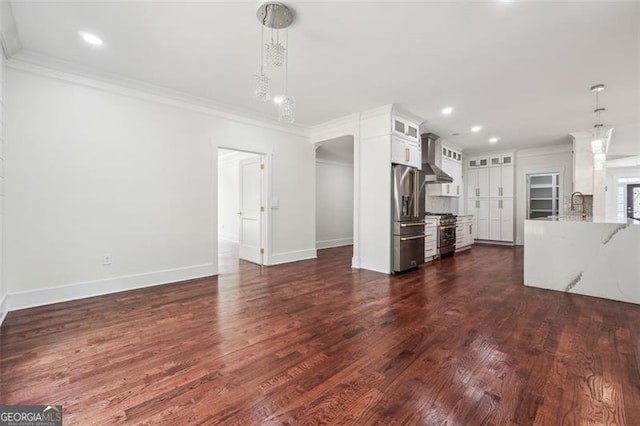 unfurnished living room with sink, ornamental molding, and dark hardwood / wood-style flooring