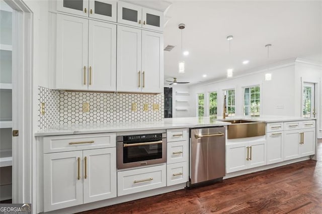 kitchen featuring dark wood-type flooring, pendant lighting, tasteful backsplash, appliances with stainless steel finishes, and crown molding