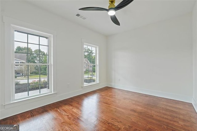 unfurnished room with ceiling fan and wood-type flooring