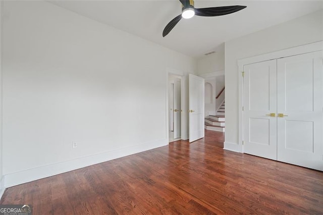 unfurnished bedroom with a closet, ceiling fan, and hardwood / wood-style floors