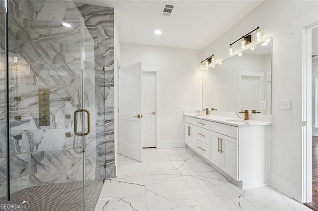 bathroom featuring tile patterned flooring, an enclosed shower, and vanity