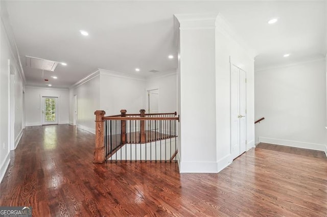 hall with hardwood / wood-style flooring and crown molding