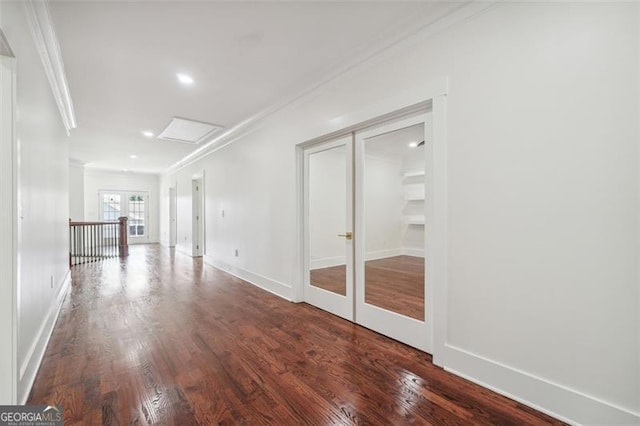 hallway with ornamental molding, hardwood / wood-style flooring, and french doors