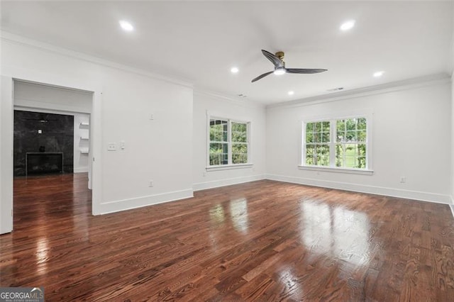 unfurnished room featuring ceiling fan, dark wood-type flooring, and ornamental molding