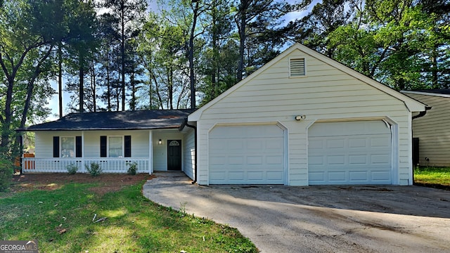 single story home with a garage and covered porch