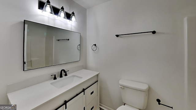 bathroom featuring toilet and vanity