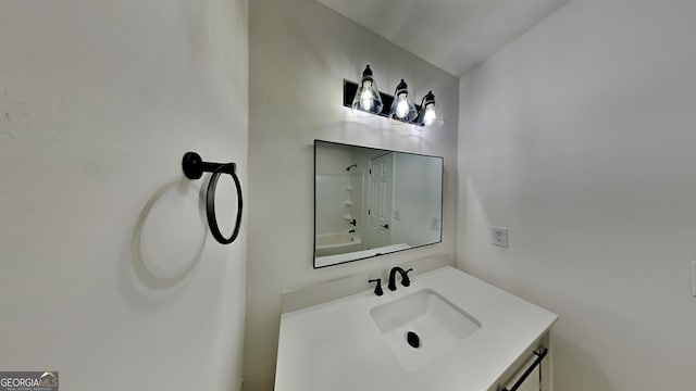 bathroom featuring shower / tub combination and vanity