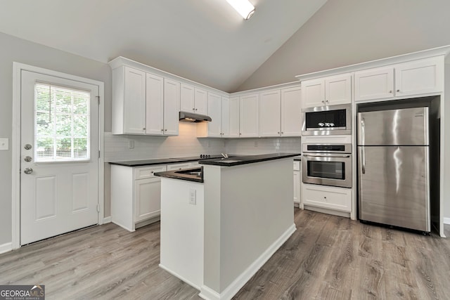 kitchen with stainless steel appliances, white cabinets, tasteful backsplash, and light hardwood / wood-style flooring