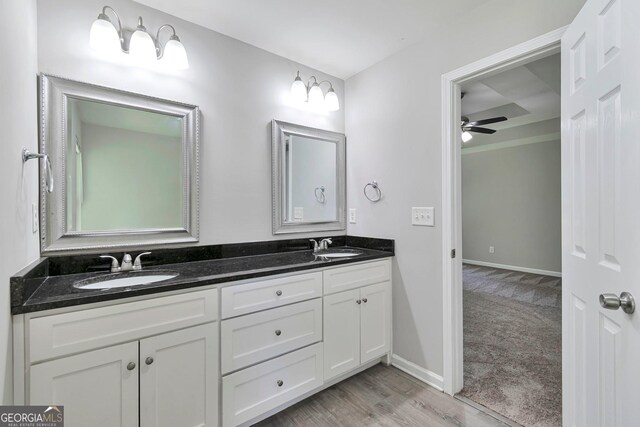 bathroom featuring ceiling fan, vanity, and wood-type flooring