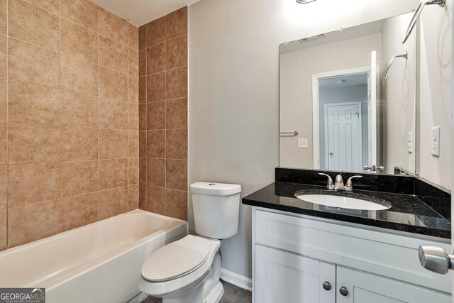 full bathroom with toilet, tiled shower / bath combo, and vanity