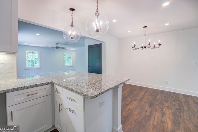 kitchen featuring pendant lighting, white cabinetry, ceiling fan, and dark wood-type flooring