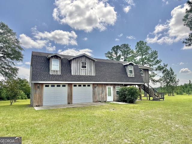 view of front of house with roof with shingles, stairway, a front yard, a garage, and driveway