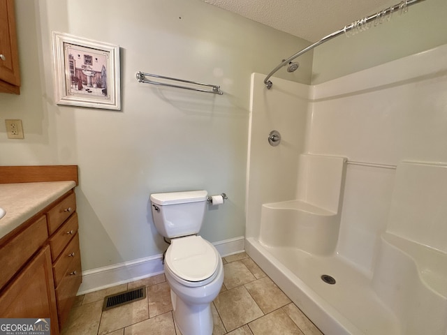 full bathroom with a shower stall, vanity, visible vents, and tile patterned floors