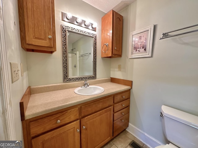 bathroom featuring visible vents, toilet, tile patterned flooring, a textured ceiling, and vanity