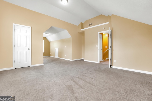 additional living space featuring lofted ceiling, carpet flooring, visible vents, and baseboards
