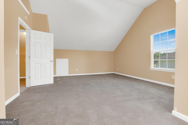 bonus room featuring carpet floors, baseboards, and vaulted ceiling