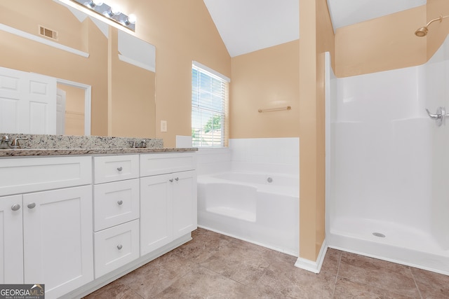 bathroom featuring tile patterned flooring, vaulted ceiling, separate shower and tub, and vanity