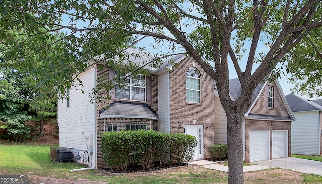 view of front of house featuring a garage and cooling unit